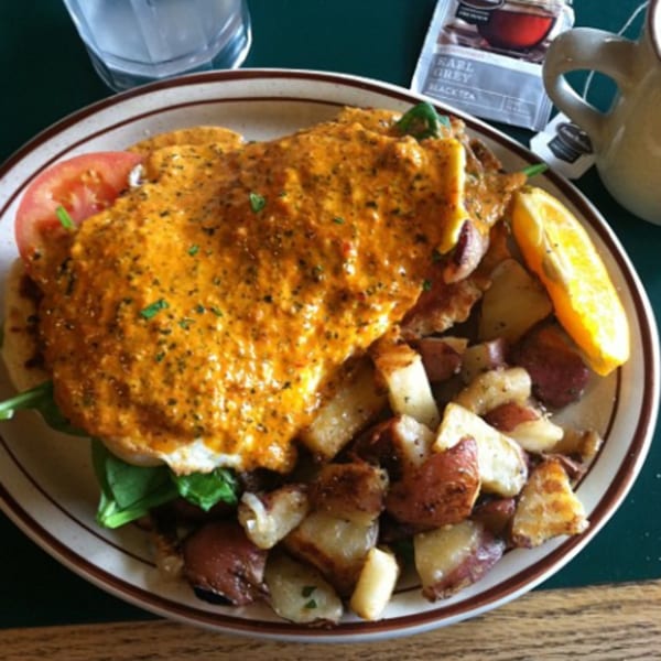 Mother Hubbard's breakfast plate with eggs benedict, home fries, and a side of Earl Grey tea.
